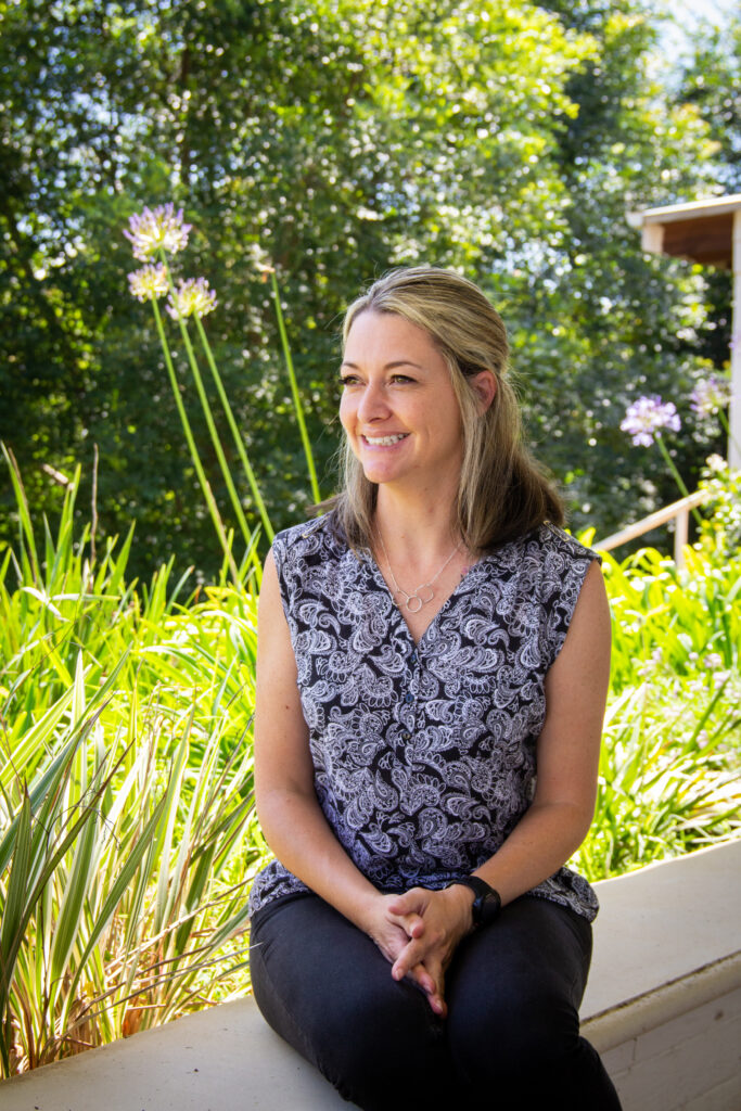 Kate-Marie in garden with black and white shirt not looking at camera